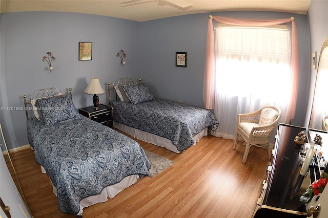 bedroom featuring wood-type flooring and ceiling fan