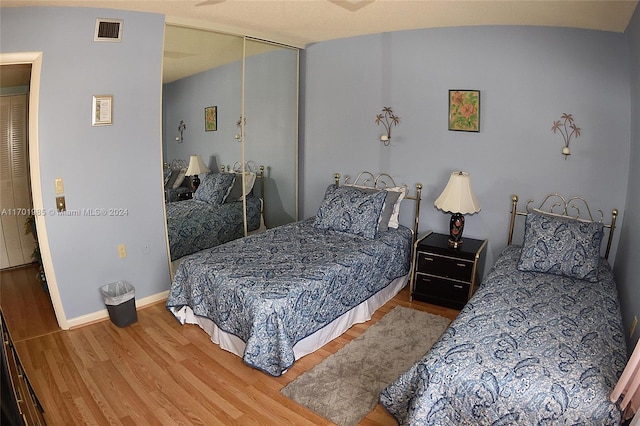 bedroom with hardwood / wood-style flooring and a closet