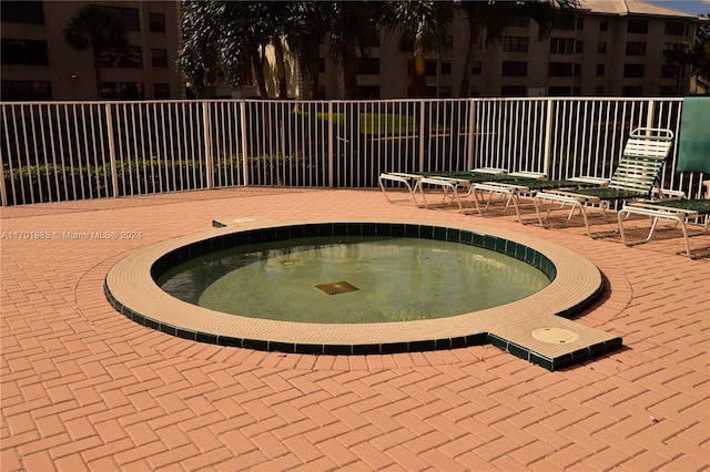 view of pool featuring a hot tub