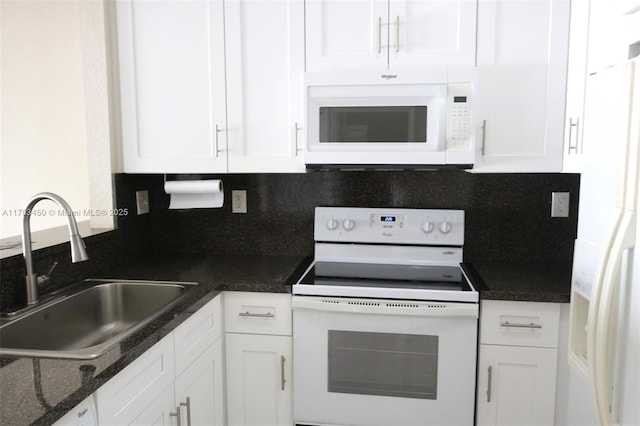 kitchen with white appliances, backsplash, sink, dark stone countertops, and white cabinetry