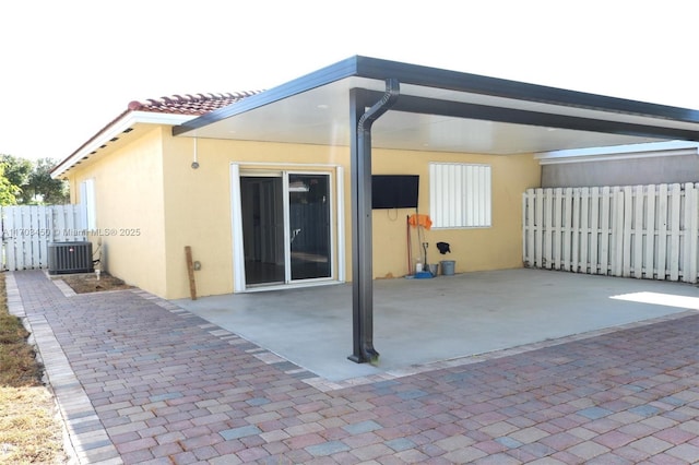 exterior space featuring central AC unit and a patio