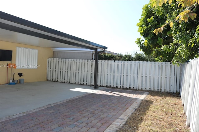 view of gate with a patio