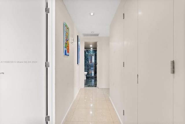 corridor featuring light tile patterned floors