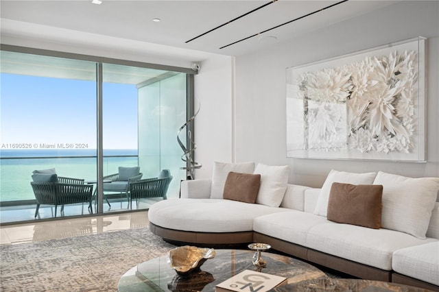 living room with hardwood / wood-style floors, a water view, and a wealth of natural light