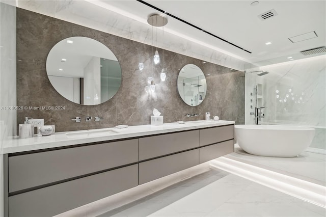 bathroom with decorative backsplash, vanity, and tile walls