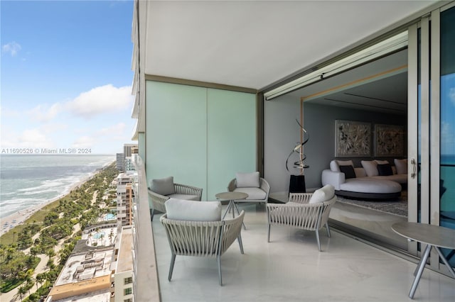 balcony featuring a view of the beach and a water view