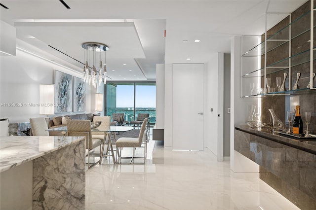 dining space with expansive windows and a water view