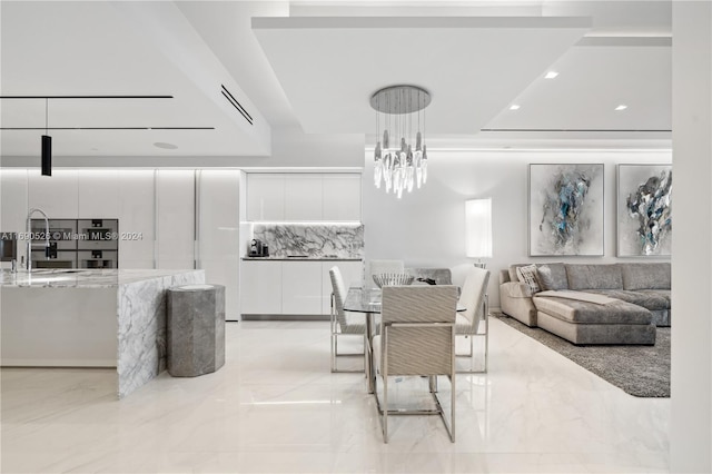 dining space with a notable chandelier and sink