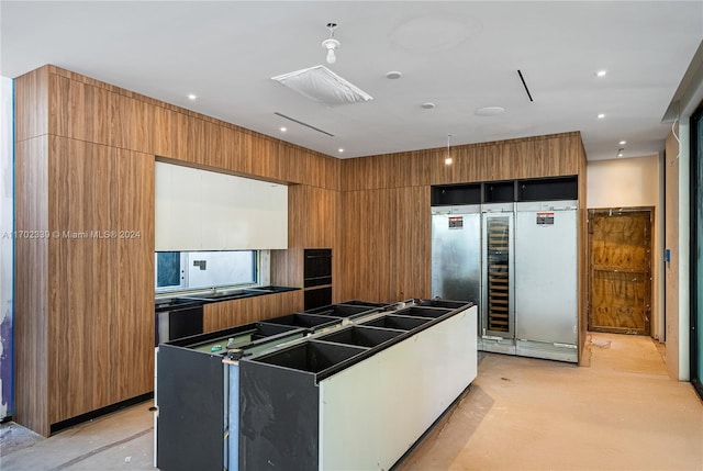 kitchen with built in fridge and wood walls