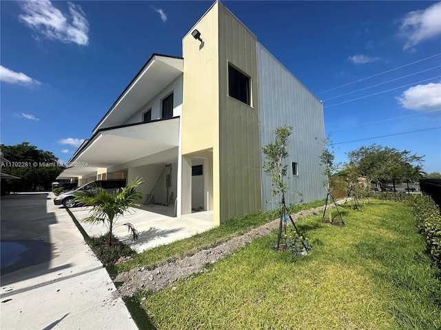 view of side of home featuring a lawn