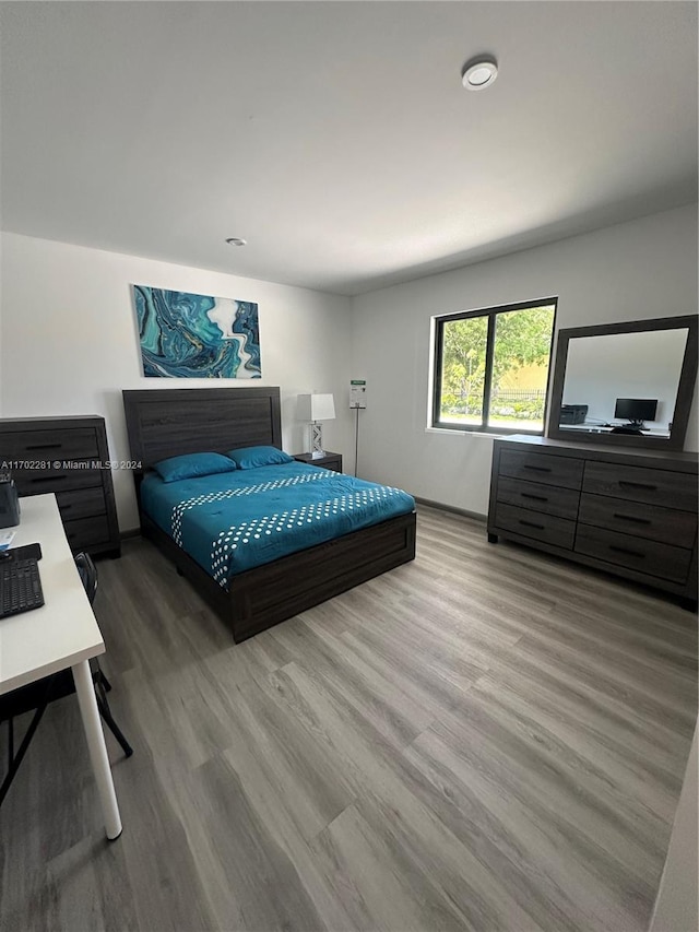 bedroom with wood-type flooring