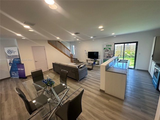 dining area with hardwood / wood-style floors and sink