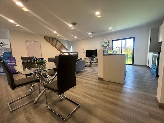 dining room with wood-type flooring and sink