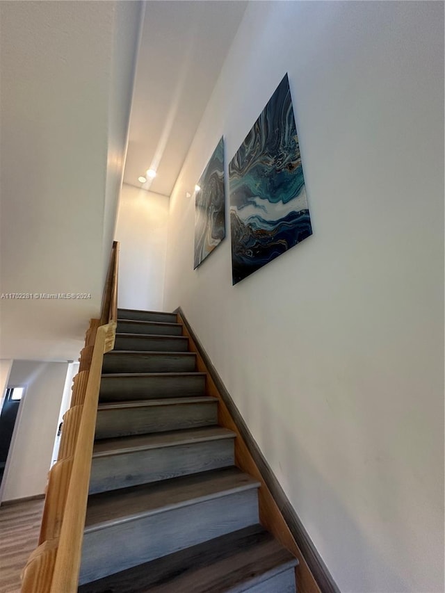 stairs with hardwood / wood-style floors