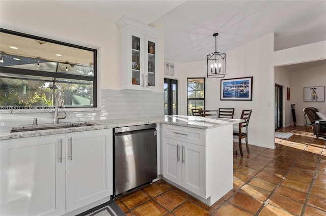 kitchen featuring white cabinets, decorative backsplash, light stone counters, and dishwasher