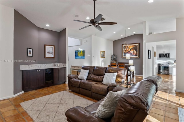 living room with ceiling fan, sink, and high vaulted ceiling