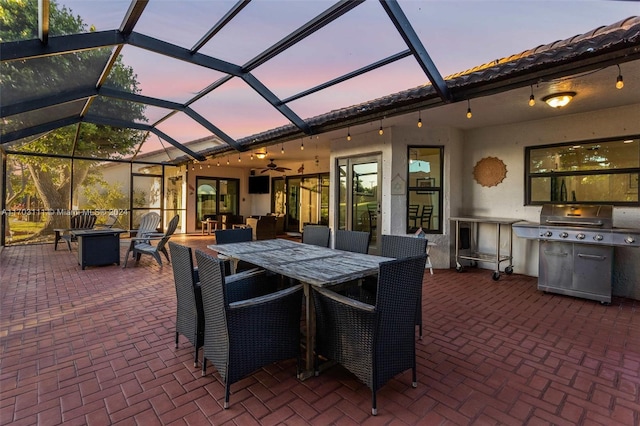 view of patio with outdoor lounge area, ceiling fan, a lanai, and a grill