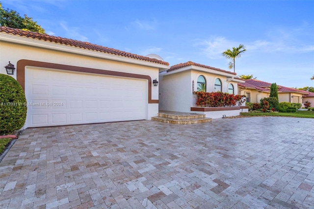 mediterranean / spanish house featuring a garage