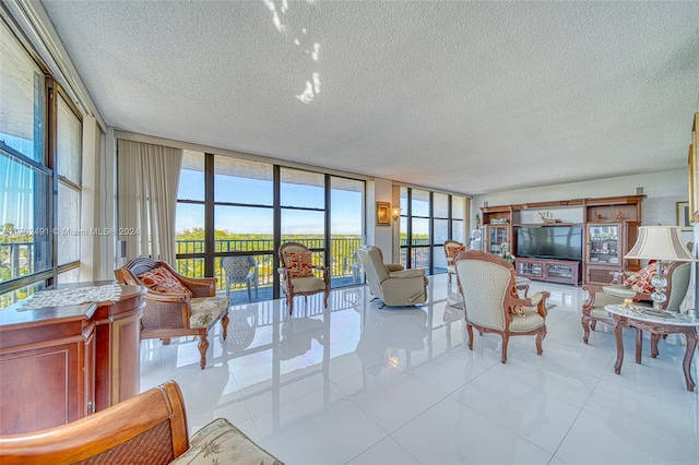 tiled living room with expansive windows, a healthy amount of sunlight, and a textured ceiling