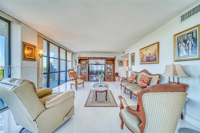 tiled living room featuring a textured ceiling