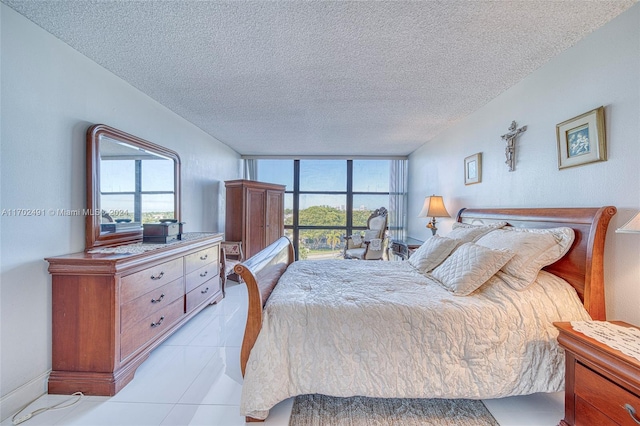 tiled bedroom featuring a textured ceiling