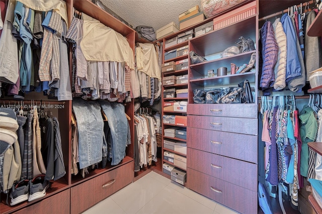 walk in closet with light tile patterned flooring