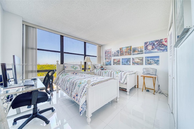 bedroom with light tile patterned floors and a textured ceiling