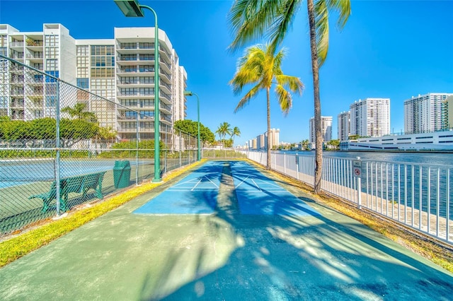 view of sport court featuring a water view