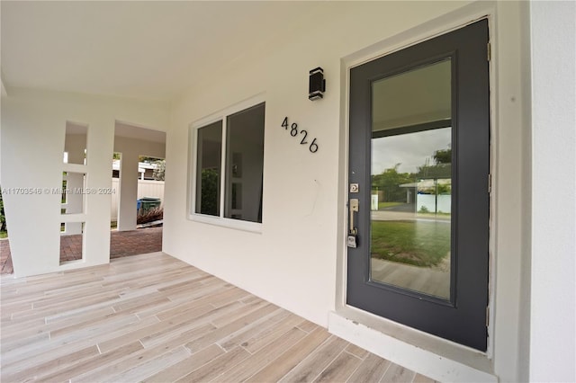 view of exterior entry featuring a porch