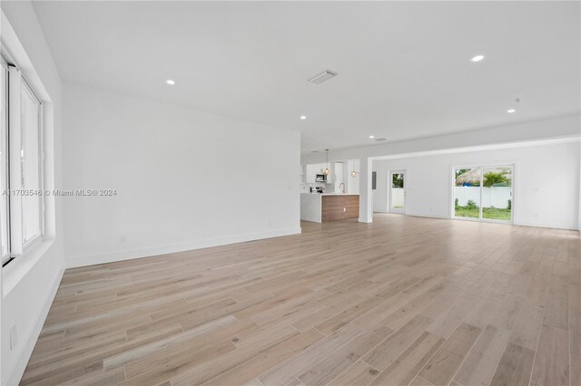 unfurnished living room with light hardwood / wood-style flooring