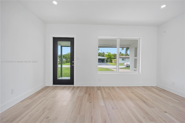 unfurnished room featuring a wealth of natural light and light hardwood / wood-style flooring