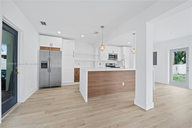 kitchen featuring electric panel, appliances with stainless steel finishes, decorative light fixtures, white cabinets, and light wood-type flooring