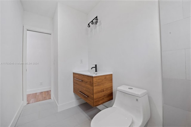 bathroom featuring tile patterned floors, vanity, and toilet