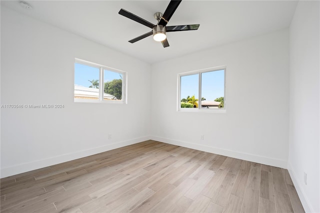 spare room with ceiling fan, plenty of natural light, and light hardwood / wood-style floors