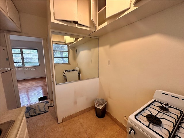 laundry area with light tile patterned floors