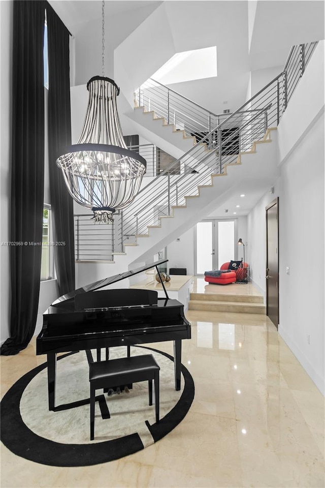 misc room with a high ceiling and an inviting chandelier