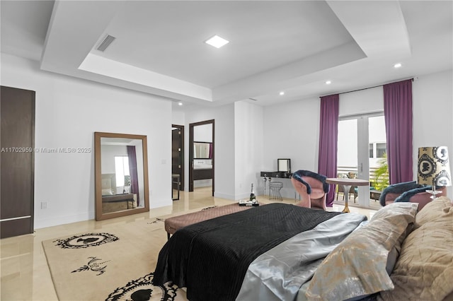 tiled bedroom featuring a tray ceiling