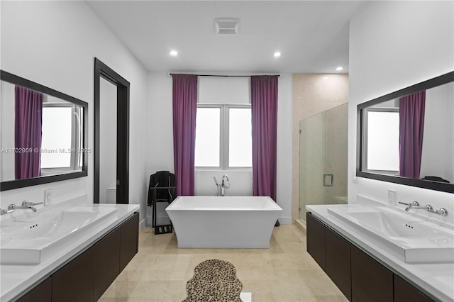 bathroom featuring separate shower and tub and vanity