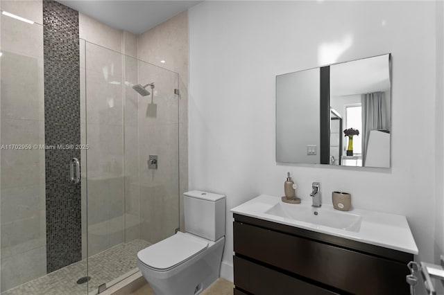 bathroom featuring an enclosed shower, vanity, and toilet