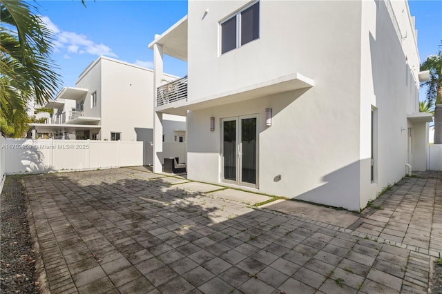 back of property with a patio and french doors