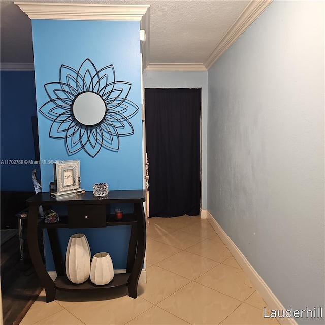 hall featuring tile patterned floors, crown molding, and a textured ceiling