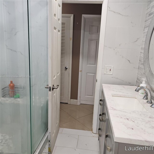 bathroom featuring vanity and an enclosed shower