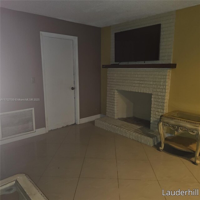 living room featuring tile patterned flooring and a brick fireplace