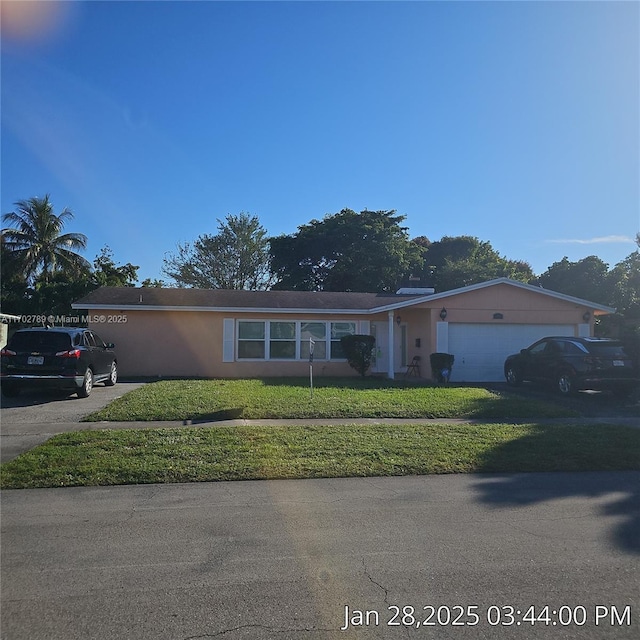 single story home with a garage and a front lawn