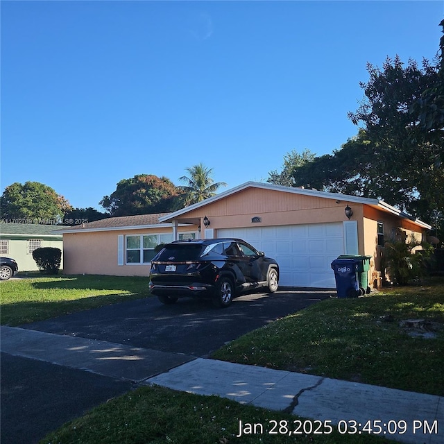 view of front of house featuring a garage and a front lawn