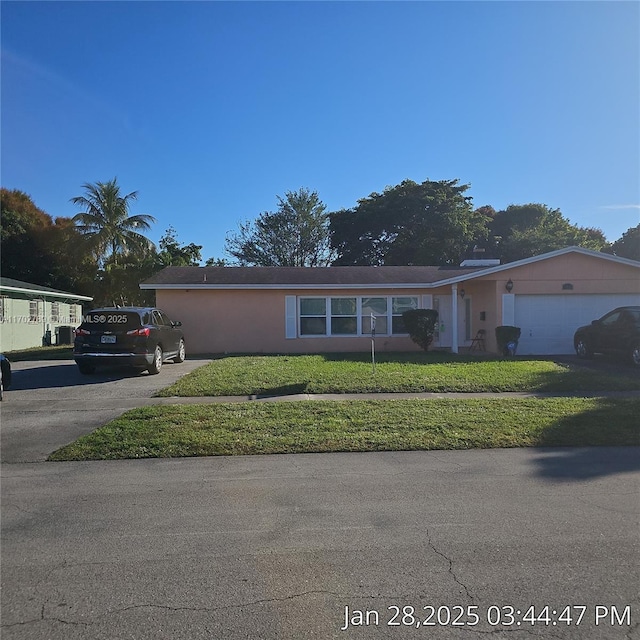 single story home featuring a garage and a front lawn