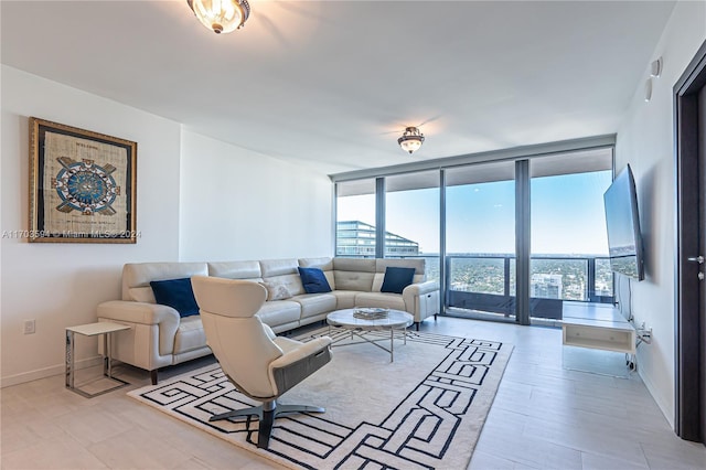 living room with floor to ceiling windows and light hardwood / wood-style flooring