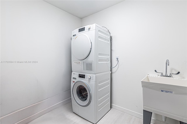 1000 Brickell Plz Unit 3806, Miami, FL 33131 - washroom featuring stacked washer and clothes dryer and baseboards