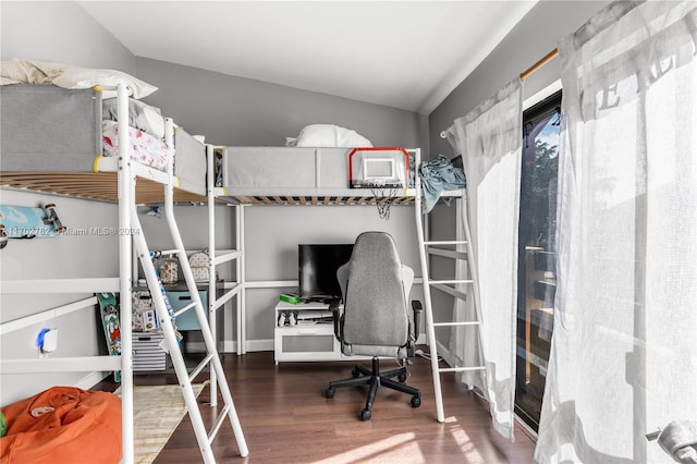 bedroom featuring wood-type flooring and vaulted ceiling