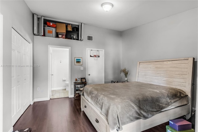 bedroom featuring ensuite bath, a closet, and dark hardwood / wood-style floors